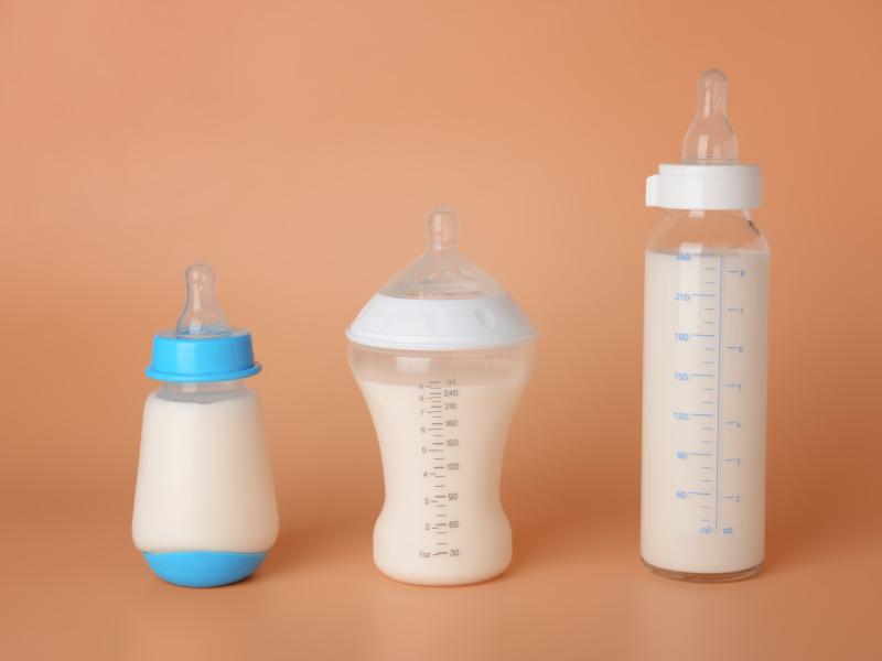 row of baby bottles full of formula