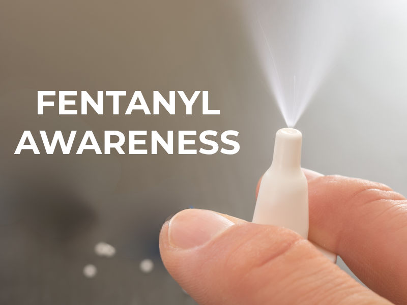 Fentanyl awareness photo with hand spraying naloxone nasal spray