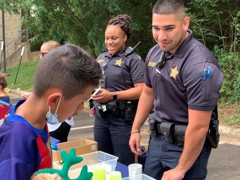 two deputies at community event with youth