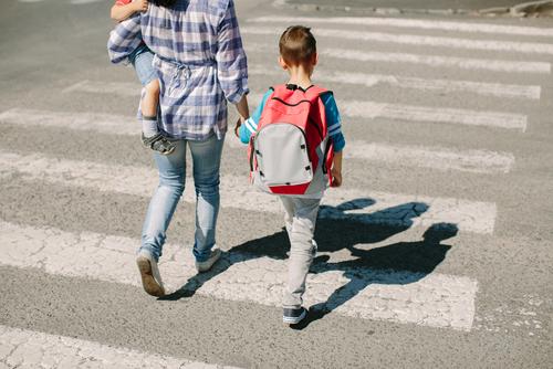 Photo of child and adult in crosswalk on way to school