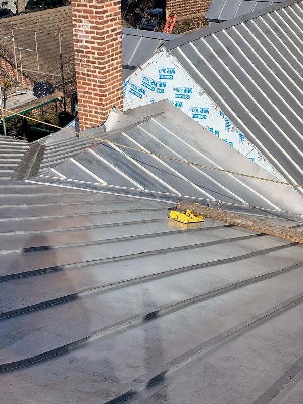 Cricket with stainless steel standing seam roof