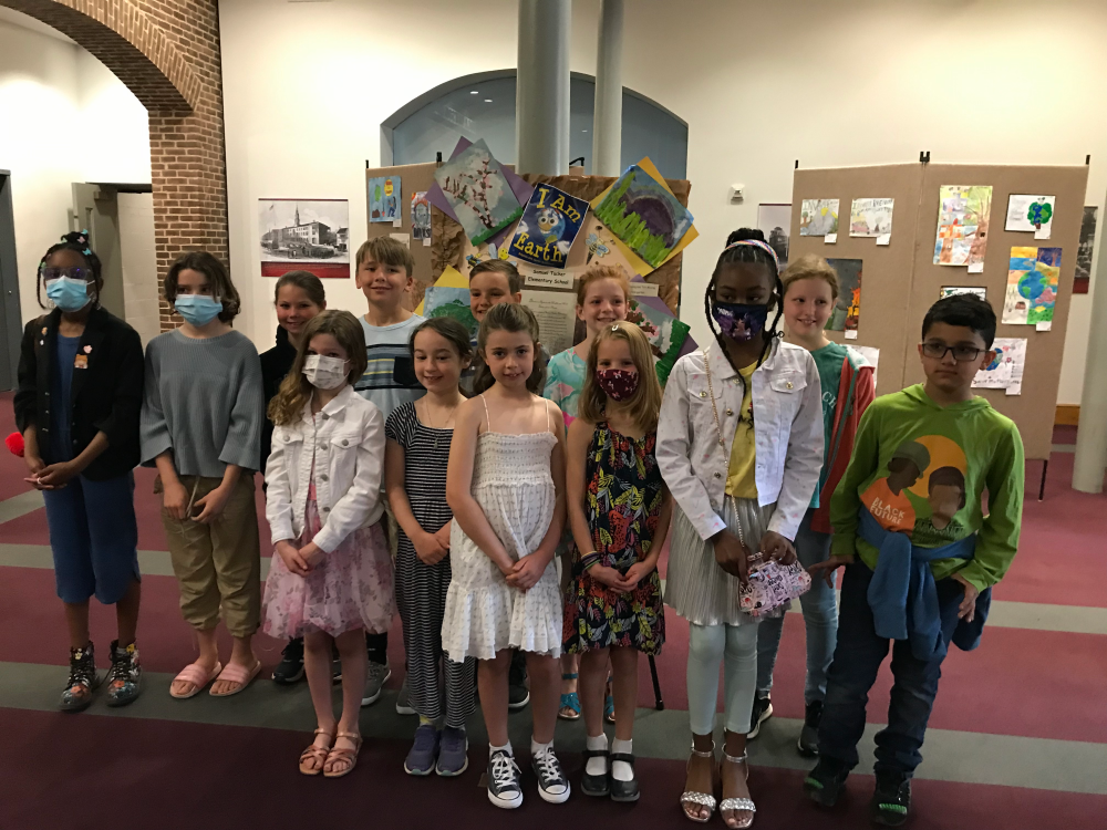 Alexandria City Public School students post in front of their 2022 Earth Day Art Contest entries.