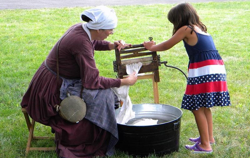 Reenactor demonstrates civil war laundry practices with help of a Camp Day guest