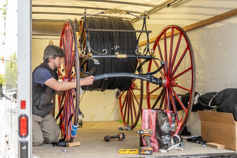 Josiah Wagner, conservator prepares to move the hose reel from the truck