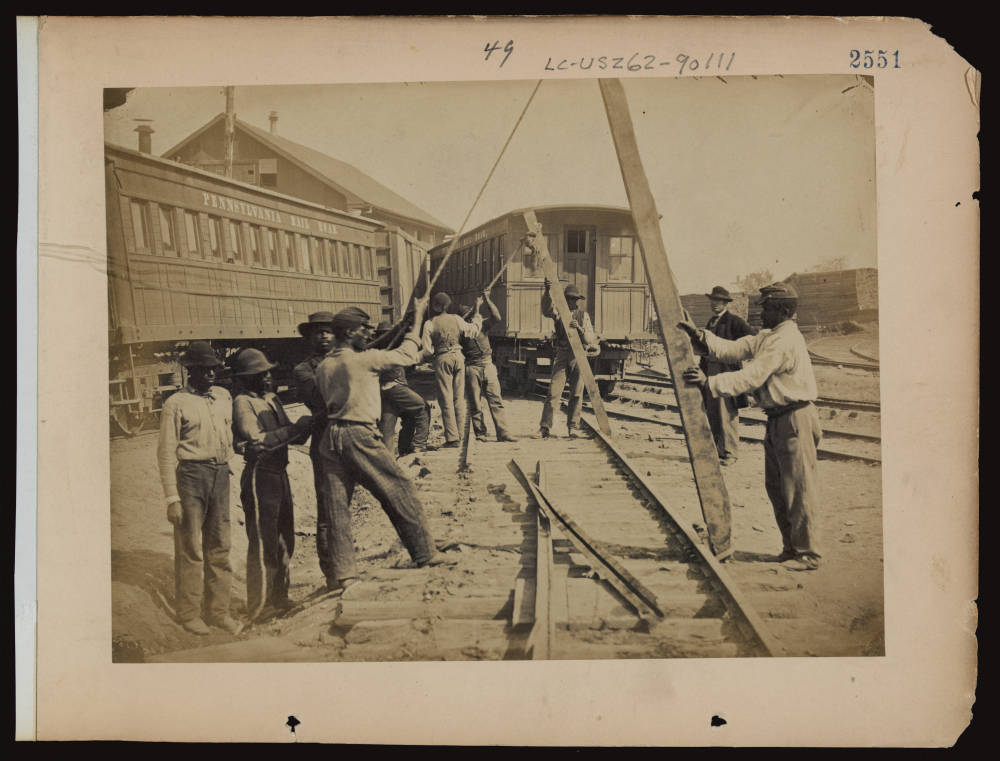 [Military railroad operations in northern Virginia: men using levers for loosening rails]