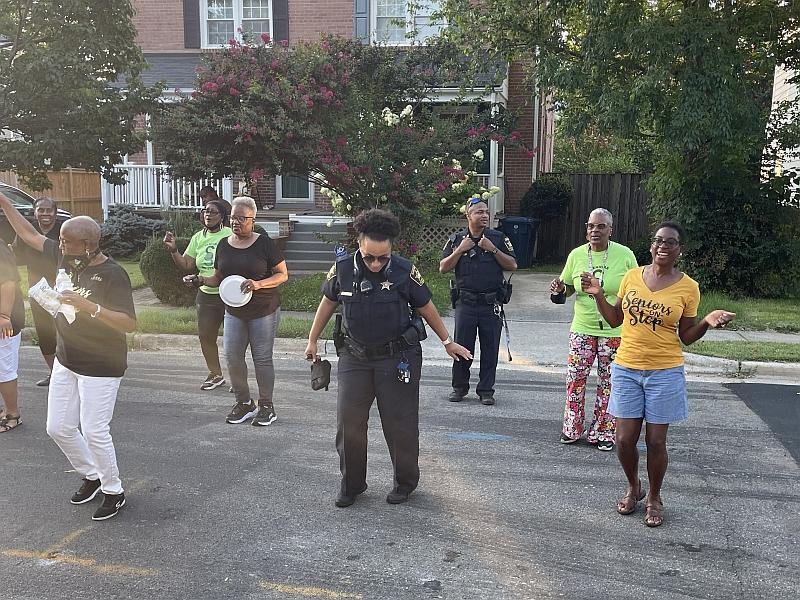two deputies and several citizens dancing in street