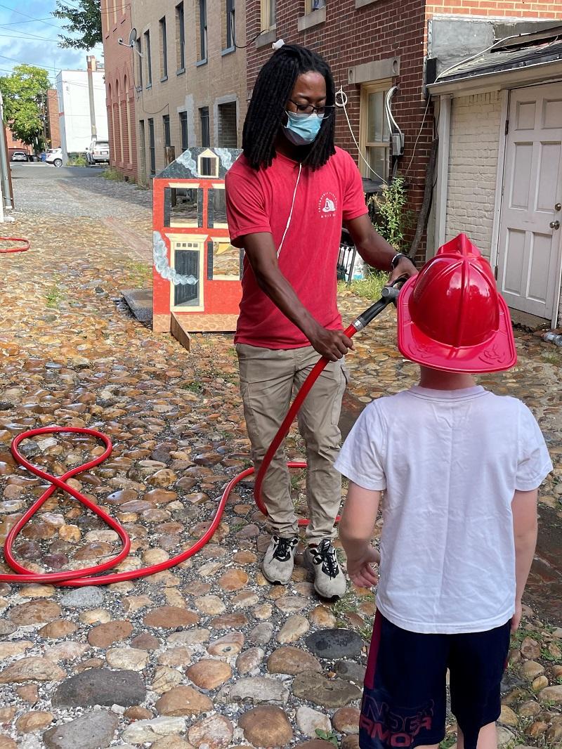 Friendship Firehouse Festival, hose activity with intern, 2022