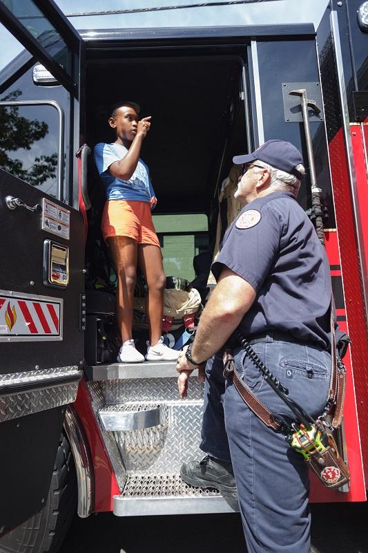 Friendship Firehouse Festival, truck with child and firefighter, 2022
