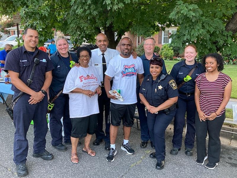 public safety personnel and citizens at block party
