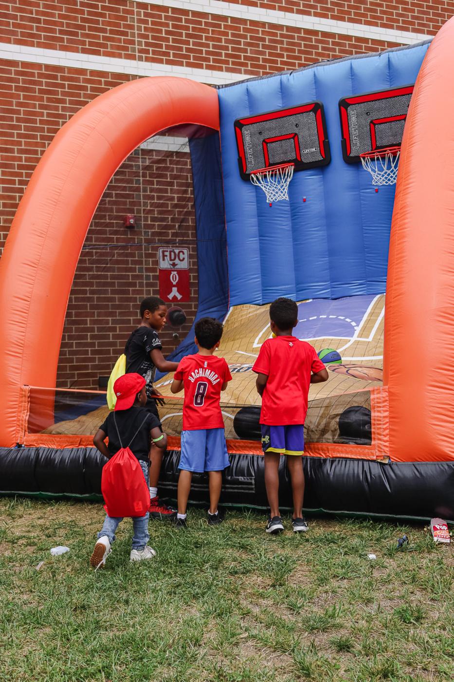 Kids shooting on blow-up basketball hoops