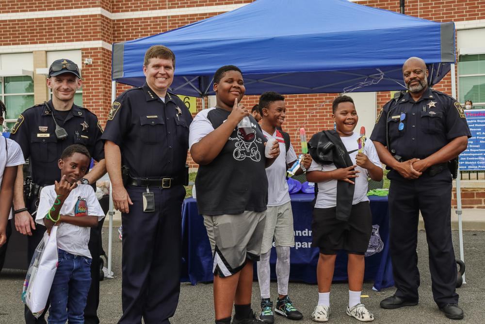 Kids and Alexandria Police smiling for the camera