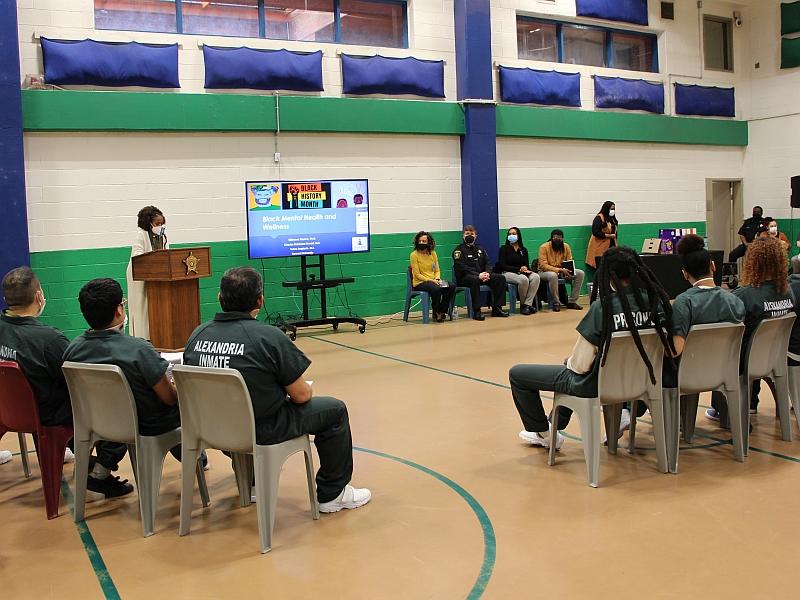 program at jail begins with guests, inmates and staff in a gym