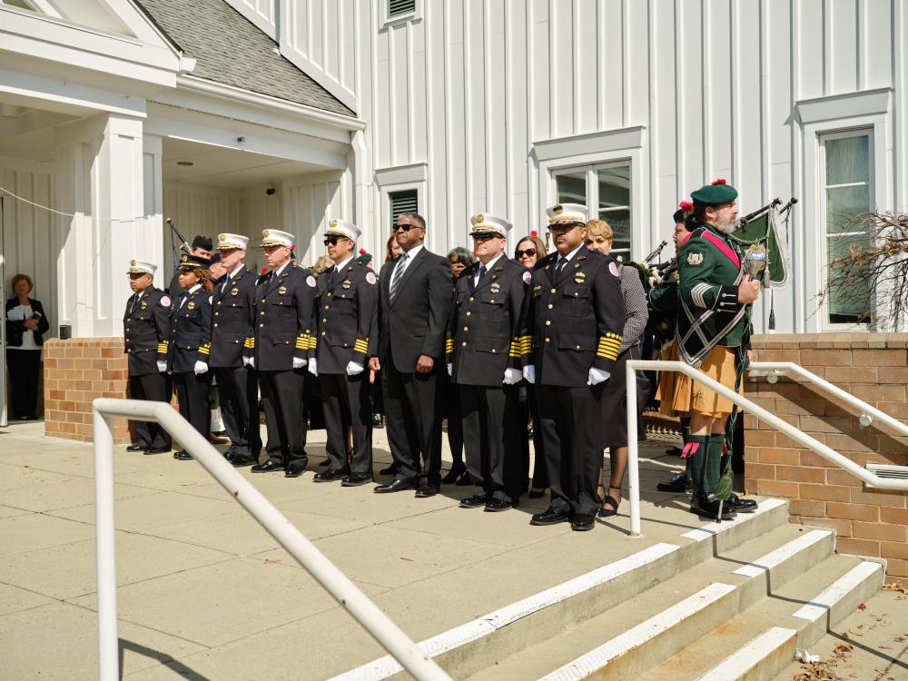 Alexandria Fire Department leadership stands at attention at Vienna Presbyterian Church as honor guard