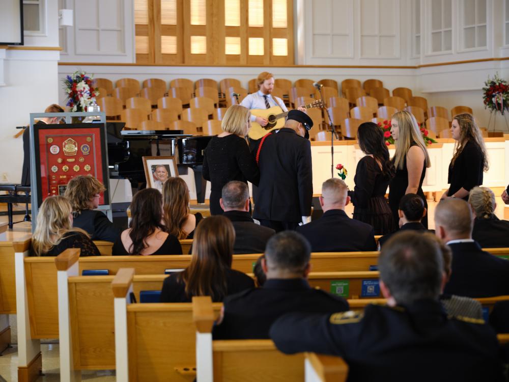Andrew and Maddie Schmidt and Brendan Cothran prepare to render a selection during the memorial service for Deputy Chief Brian Hricik on Saturday, March 11, 2023.