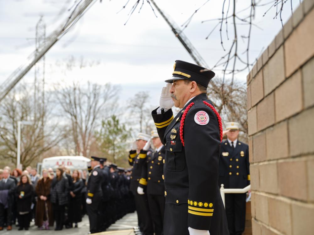 The honor guard salutes as Deputy Chief Hricik is moved to the carriage of Engine 201 after his memorial service on Saturday, March 11, 2023.