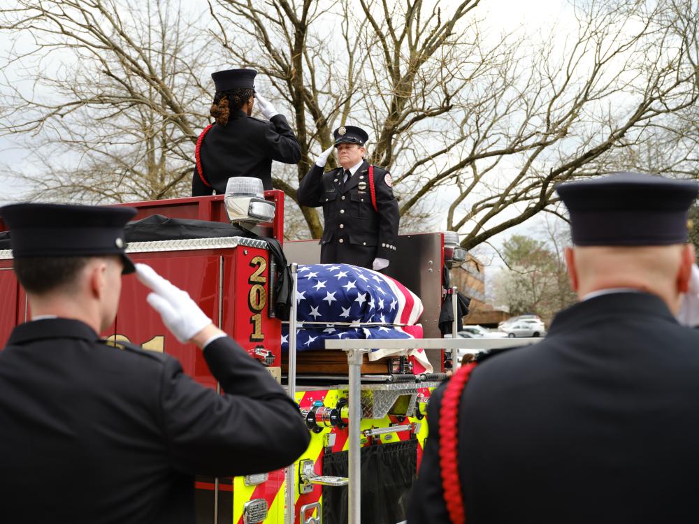 The honor guard salutes as Deputy Chief Hricik is moved to the carriage of Engine 201 after his memorial service on Saturday, March 11, 2023.