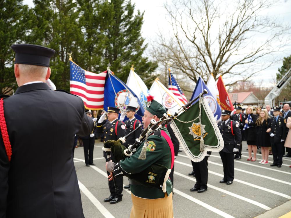 Northern Virginia Firefighters' Emerald Society Pipe Band performs "Amazing Grace" as the honor guard moves Deputy Chief Hricik to the carriage of Engine 201 after his memorial service on Saturday, March 11, 2023.
