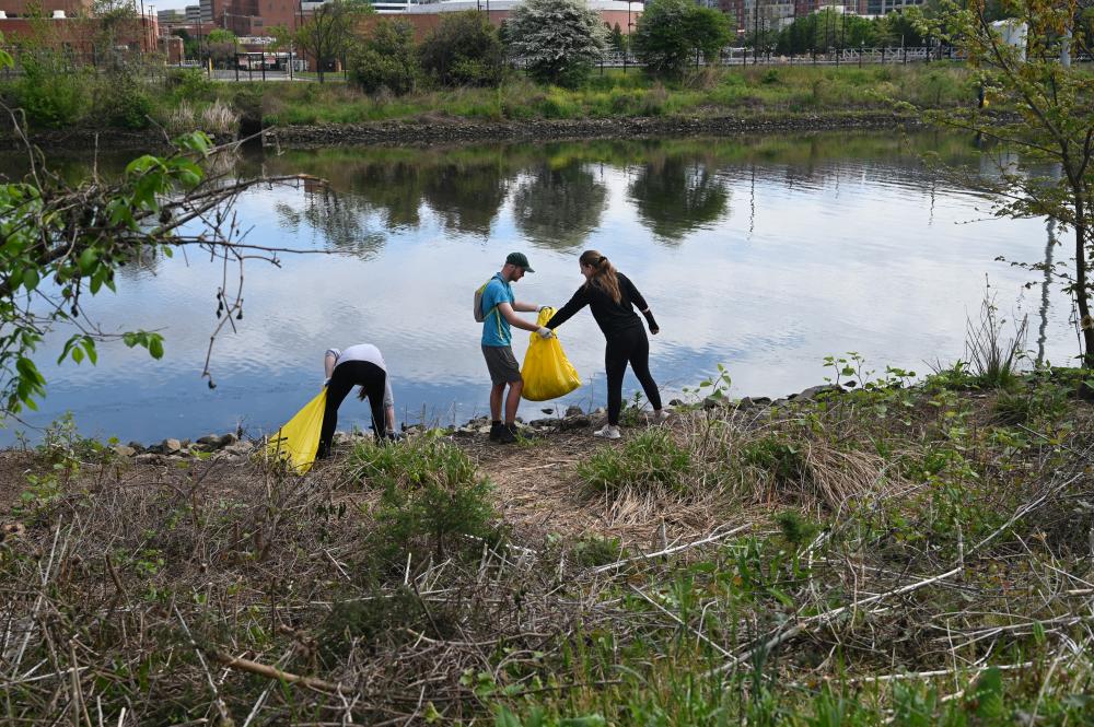 Residents participate in a stream clean-up during Earth Month 2023