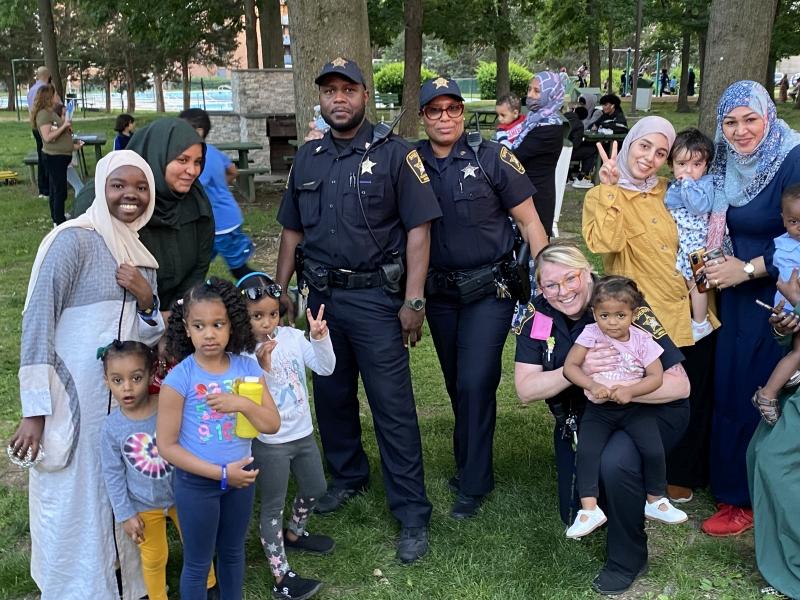three deputies and several women and children at neigborhood event