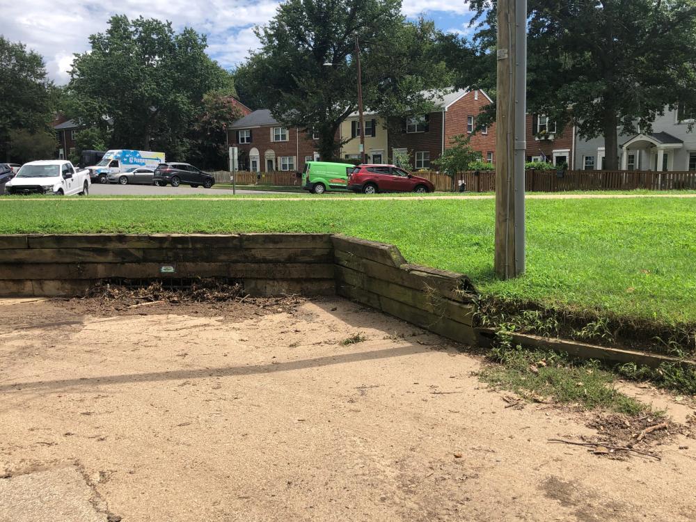 Image of retaining wall behind 65 Commonwealth Avenue collapsing due to flood damage.