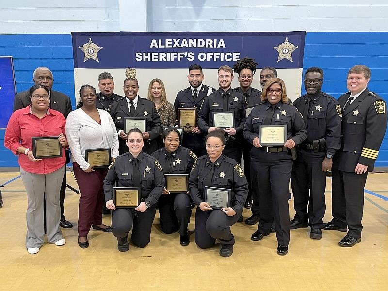 several sworn and civilian Sheriff's Office employees holding plaques at the awards ceremony