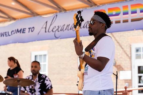 Band member playing bass during performance 