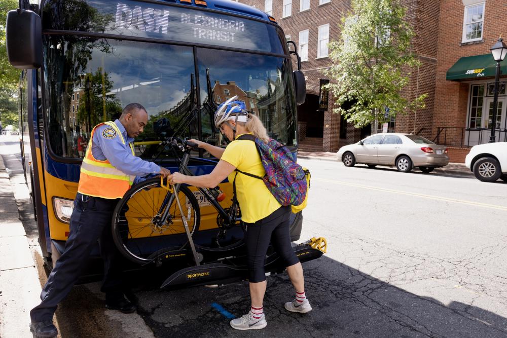Person putting bike on DASH Bus