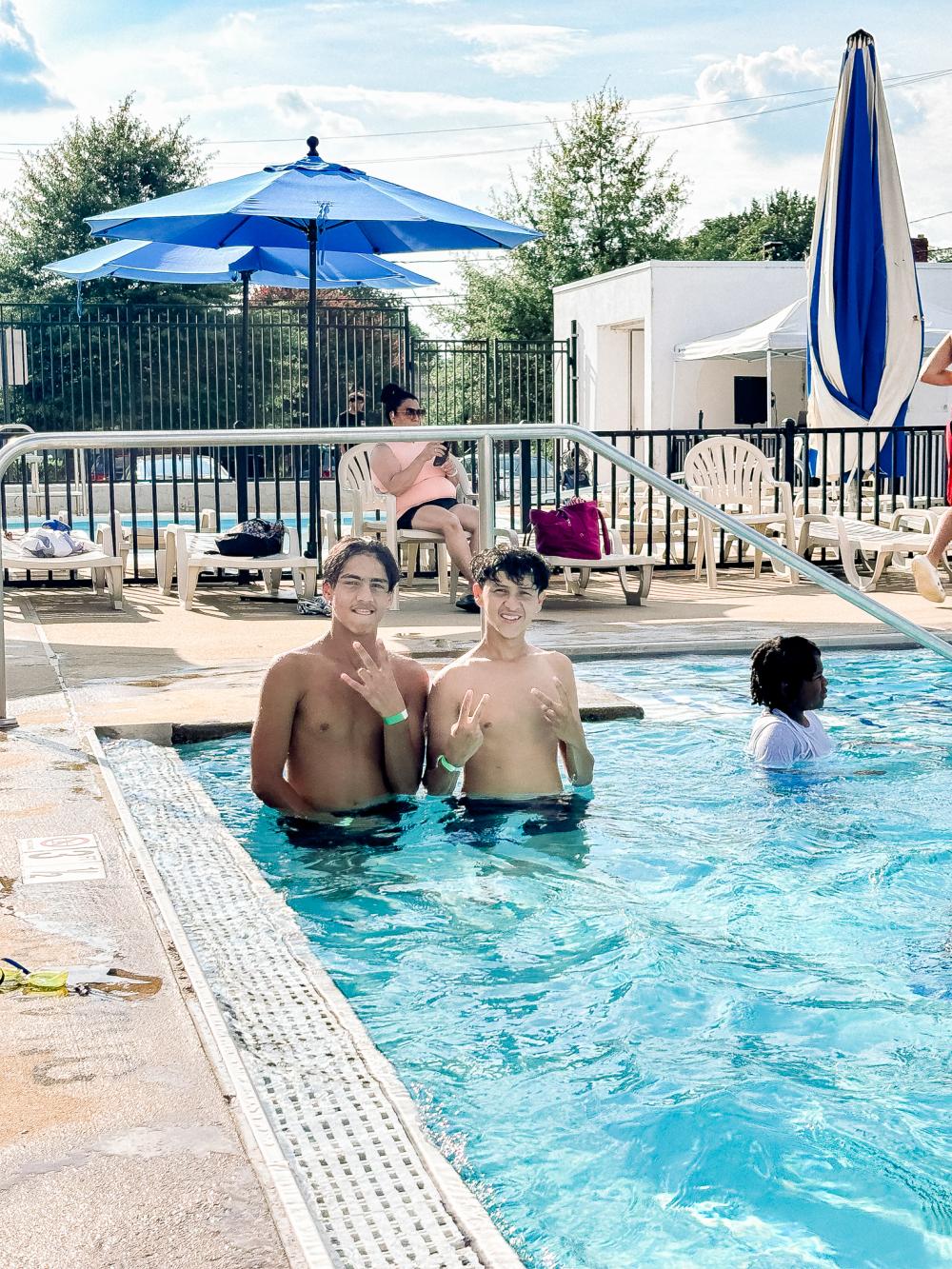 Image of two teens at an outdoor pool