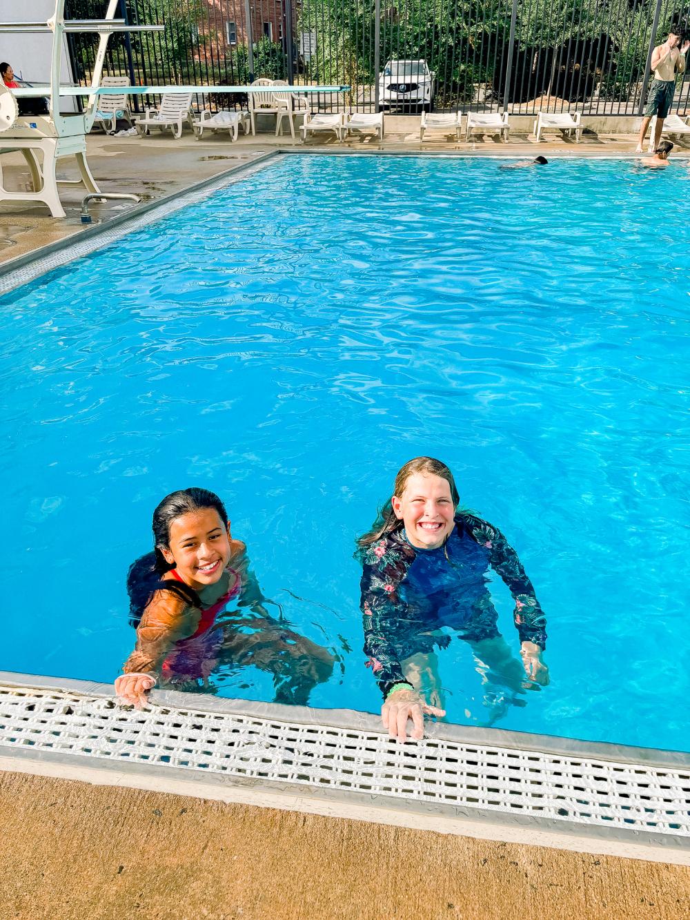 Image of two female teens in an outdoor pool