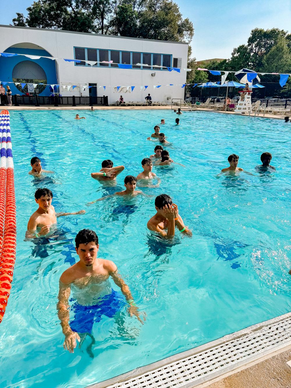 Image of teens swimming at an outdoor pool