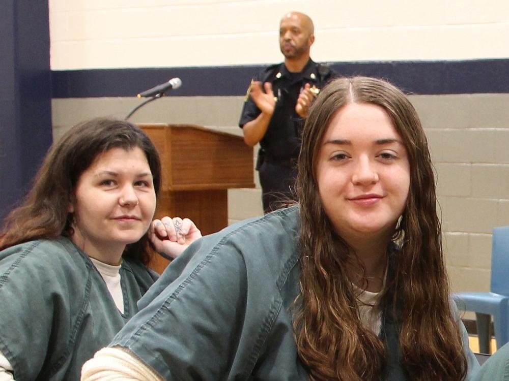 Two inmates smiling at a recognition program