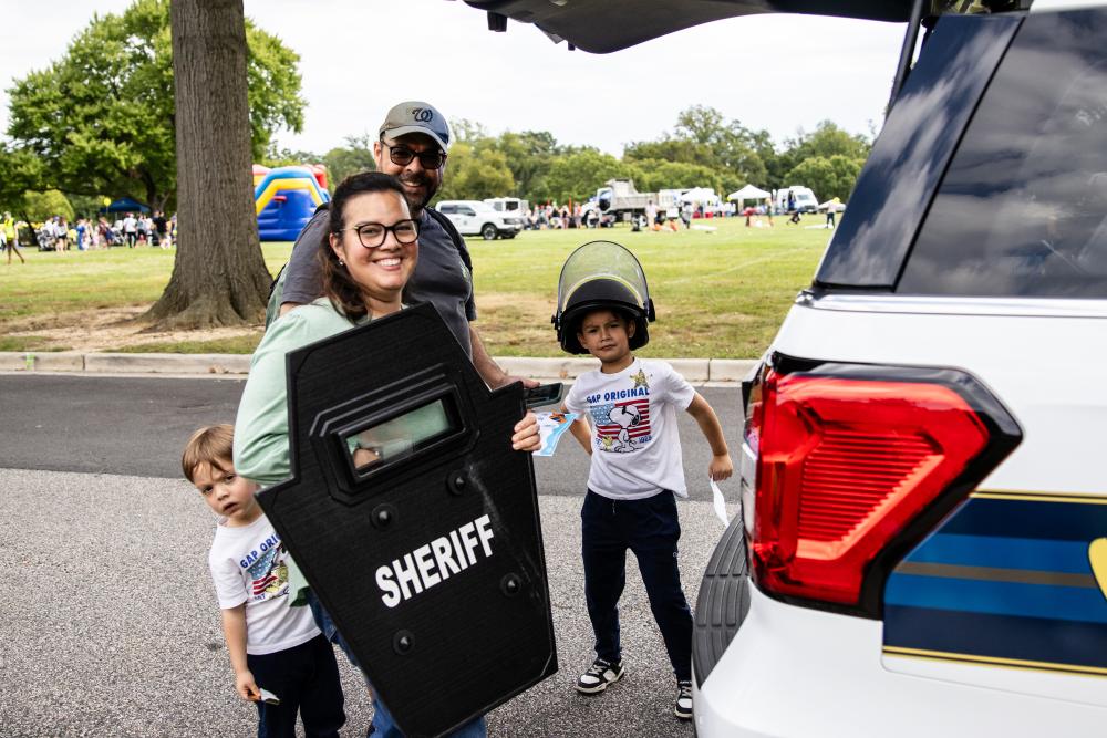 A family poses with a Sheriff Department shield