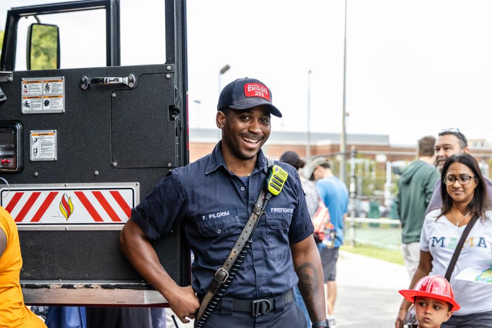 A firefighter smiles at event attendees