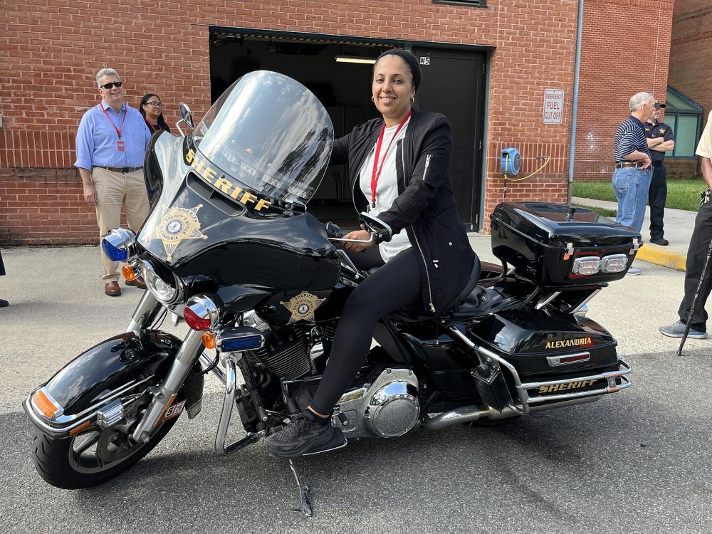 Community member sitting on a Sheriff's Office motorcycle