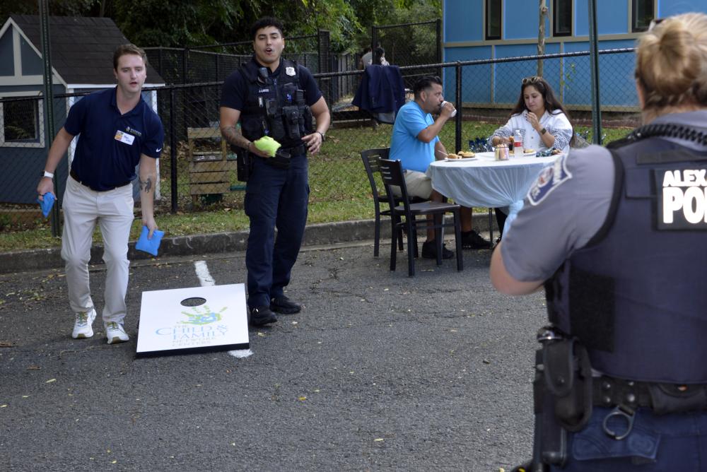 APD Officers play cornhole with Alexandrians during a Child and Family Outreach event September 9, 2025.