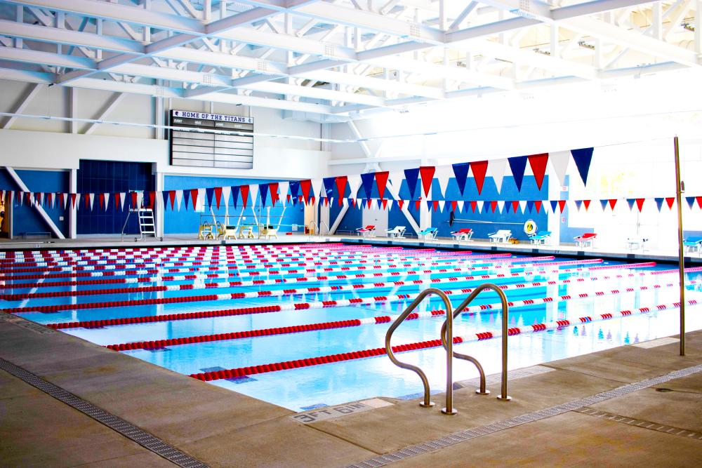 Minnie Howard's competition pool featuring several lanes, diving boards, and red, white, and blue flags above the pool