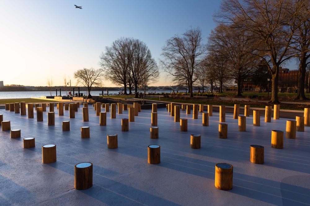 Site See Installation with a plane in the sky and the sunlight setting on the installation