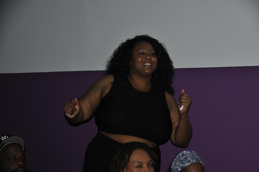 Woman dressed in black dancing 