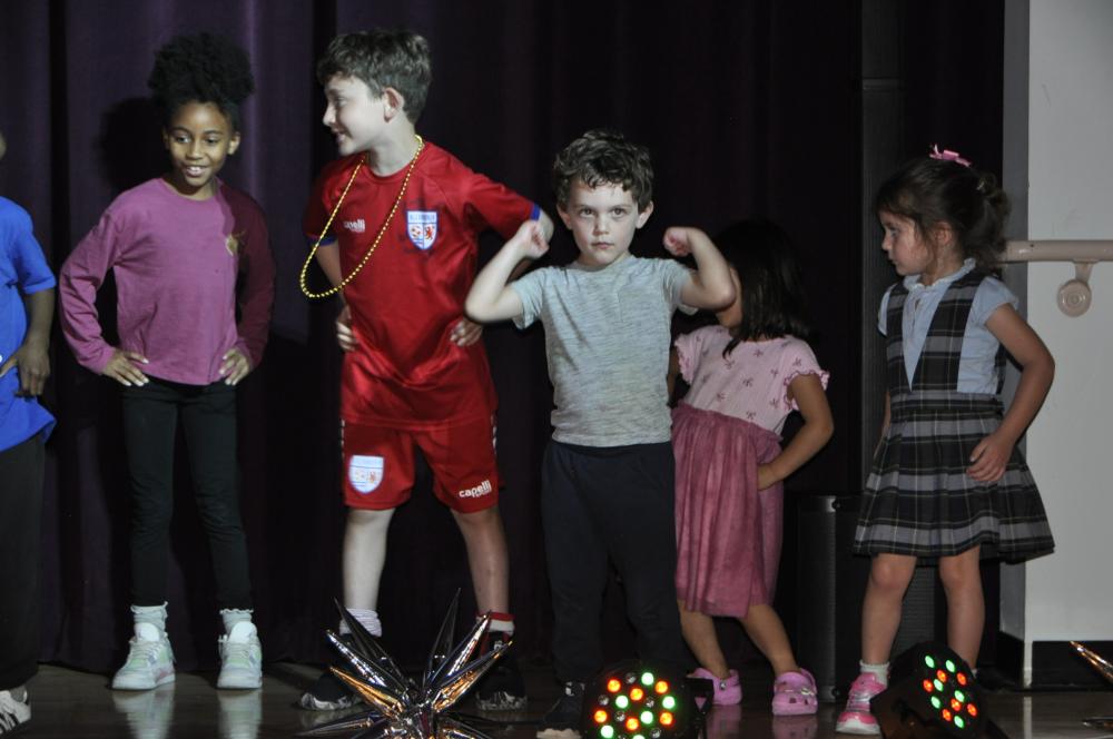 Kids dressed in casual clothes on stage