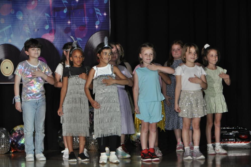 Group of kids on stage standing and posing