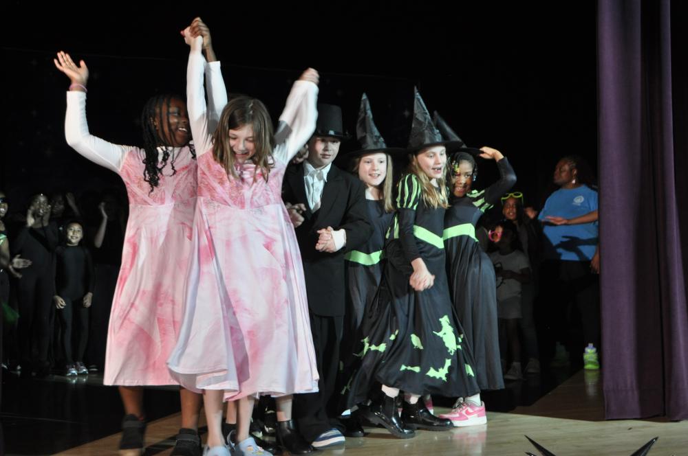 Girls wearing pink and black and green like Glinda and Elphaba