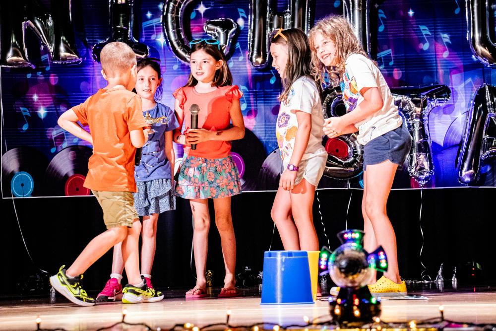 Performers on the stage holding a mic