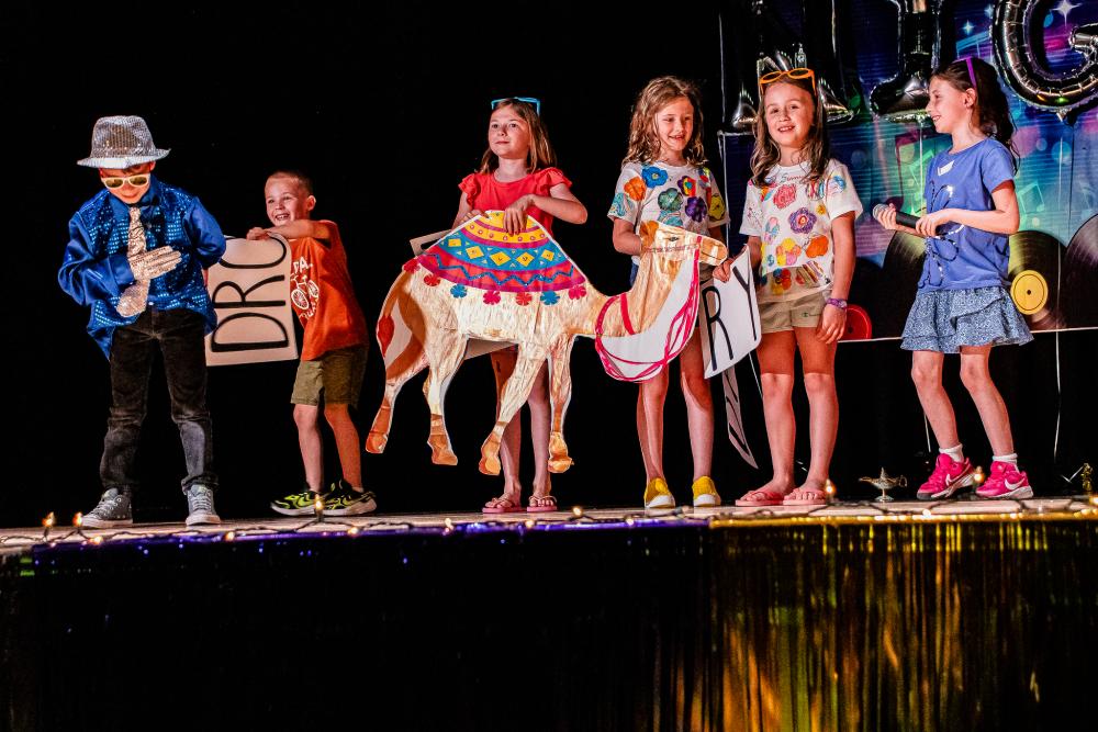 Performers standing around on stage