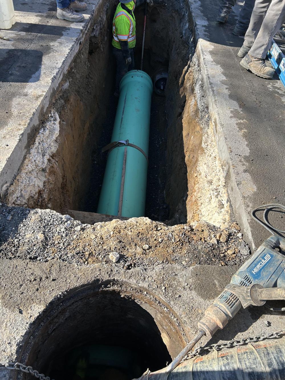 The new pipe is placed into the trench and connected to the existing manhole.  