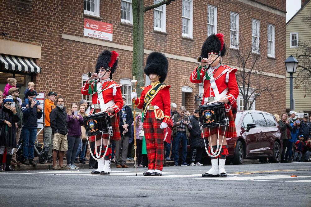 three men with instruments dressed in scottish garb