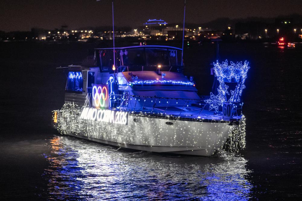 picture of boat on the water with holiday lights 