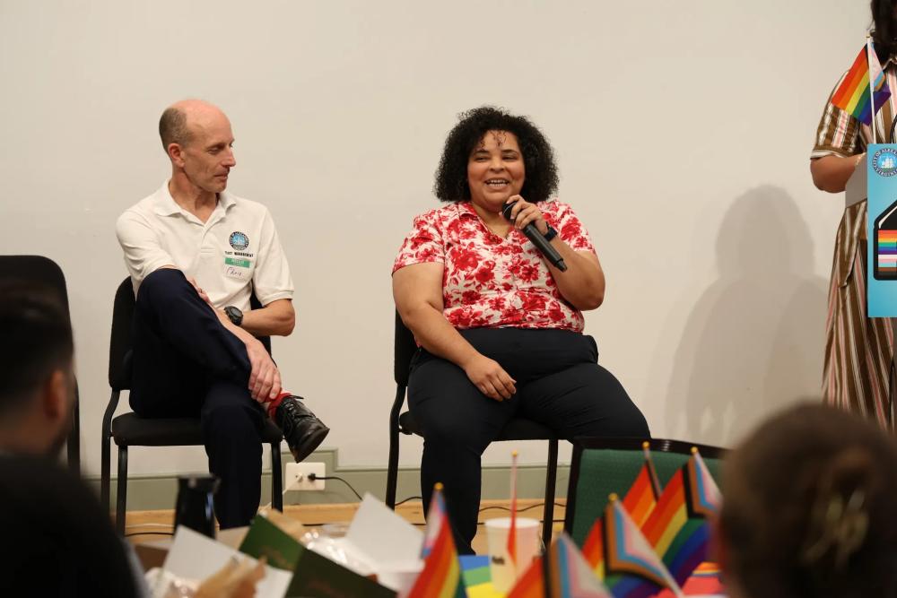 Two people speaking on panel