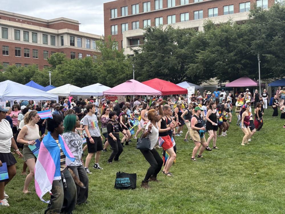 Large group line dancing at Alexandria Pride 2026