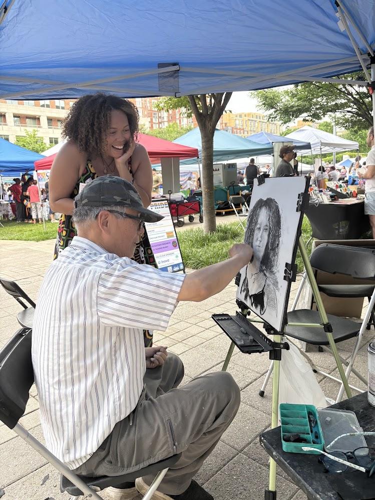 Person smiling at picture created by sketch artist