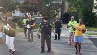 two deputies and several citizens dancing in street